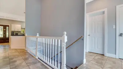 a staircase in a home with a white door at Luxury Lake Front Camelot Villa in Pocono Lake