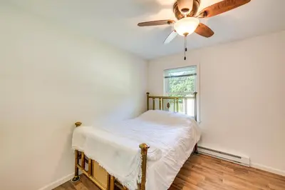 a bedroom with a bed and a ceiling fan at Quaint Elysburg Cottage Walk to Knoebels Resort! in Paxinos