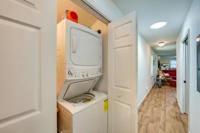a washer and dryer in a room with a hallway at Quaint Elysburg Cottage Walk to Knoebels Resort! in Paxinos