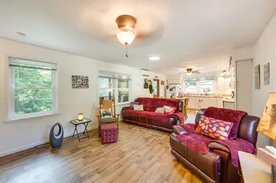 a living room with two couches and a table at Quaint Elysburg Cottage Walk to Knoebels Resort! in Paxinos