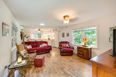 a living room with two couches and a table at Quaint Elysburg Cottage Walk to Knoebels Resort! in Paxinos