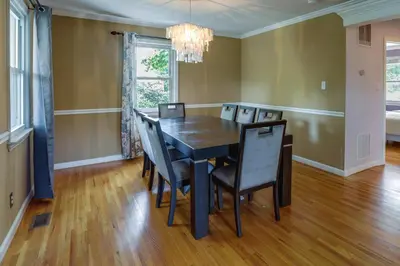a dining room with a black table and chairs at Charming Monroe Township Home - 13 Mi to RU! in East Brunswick