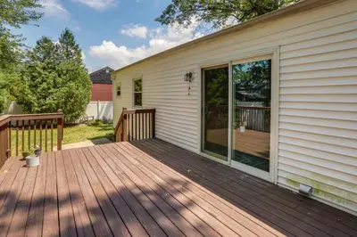 a wooden deck on the side of a house at Charming Monroe Township Home - 13 Mi to RU! in East Brunswick