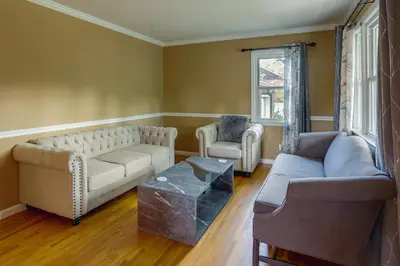 a living room with two couches and a table at Charming Monroe Township Home - 13 Mi to RU! in East Brunswick