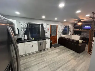 a large living room with a couch and a television at Wally's Cottage in Hawley