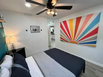 a bedroom with a bed and a painting on the wall at Wally's Cottage in Hawley