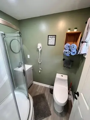 a small bathroom with a toilet and a shower at Wally's Cottage in Hawley