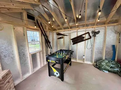 a room with a ping pong table in a house at Wally's Cottage in Hawley