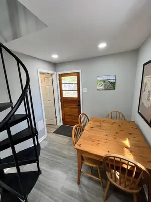 a dining room with a wooden table and chairs at Wally's Compound in Hawley