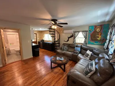 a living room with a couch and a ceiling fan at Wally's Compound in Hawley