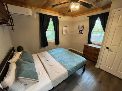 a bedroom with a bed and a ceiling fan at Wally's Compound in Hawley
