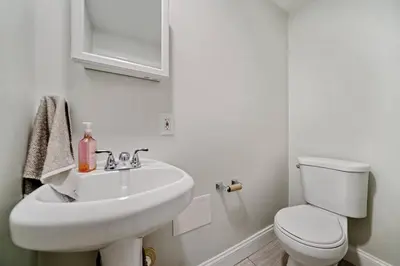 a white bathroom with a sink and a toilet at 1255 Ashbridge, West Chester, PA in West Chester