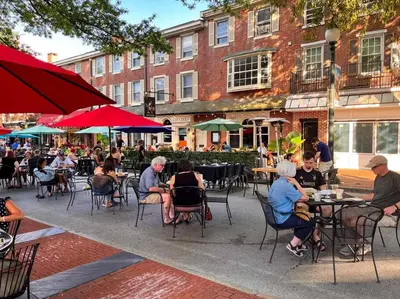a group of people sitting at tables in an outdoor cafe at 1255 Ashbridge, West Chester, PA in West Chester