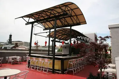a patio with a bar with chairs and tables at 1255 Ashbridge, West Chester, PA in West Chester