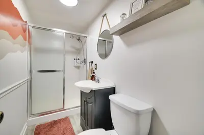 a bathroom with a shower and a toilet and a sink at Family Pocono Gem by the lake with private sauna, hot tub, and huge game room in Arrowhead Lake