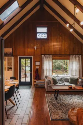 a living room with a couch and a table at Family Pocono Gem by the lake with private sauna, hot tub, and huge game room in Arrowhead Lake