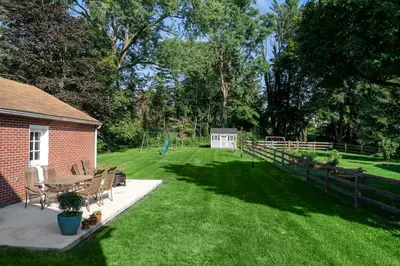 a backyard with a table and chairs and a fence at Beautiful fully-furnished Colonial in Millersville in Millersville