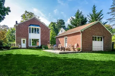 a brick house with a patio and a yard at Beautiful fully-furnished Colonial in Millersville in Millersville