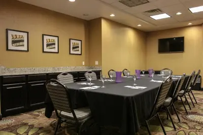 a conference room with a long table with wine glasses at Holiday Inn Express and Suites Montgomery by IHG in Montgomery