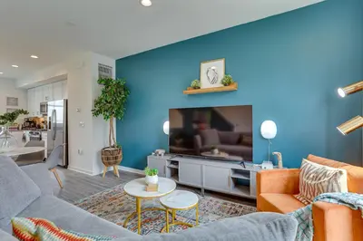 a living room with a blue accent wall at 3 Mi to Center City Philadelphia Townhome in Philadelphia