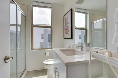 a white bathroom with a sink and a toilet at 3 Mi to Center City Philadelphia Townhome in Philadelphia