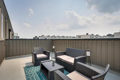 a patio with chairs and a table on a balcony at 3 Mi to Center City Philadelphia Townhome in Philadelphia