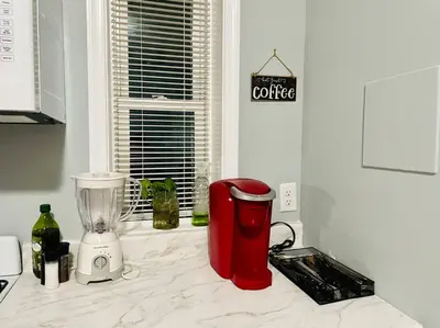 a kitchen counter with a blender on a counter top at THE ECO HOME. Entire place with private parking in Wilmington