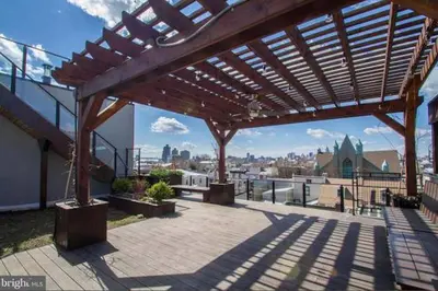 a wooden pergola on top of a building at The Fishtown Blue Jay - Garage Parking Included! in Philadelphia