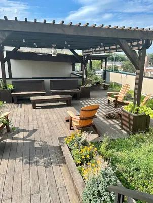 a wooden deck with benches and a wooden pergola at The Fishtown Blue Jay - Garage Parking Included! in Philadelphia