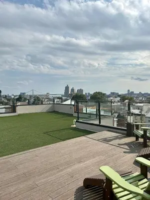a patio with a view of a green field on a roof at The Fishtown Blue Jay - Garage Parking Included! in Philadelphia