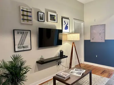 a living room with a tv and a coffee table at The Fishtown Blue Jay - Garage Parking Included! in Philadelphia