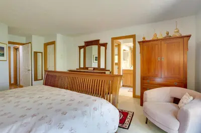 a bedroom with a bed and a chair and a mirror at Less Than 1 Mi to Camelback Resort Home with Pool Table! in Tannersville