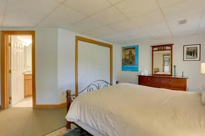 a bedroom with a bed and a dresser and a mirror at Less Than 1 Mi to Camelback Resort Home with Pool Table! in Tannersville