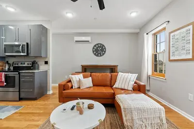 a living room with a couch and a table at Stay Rafa At 259 in Philadelphia