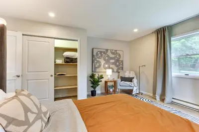 a bedroom with a large bed and a window at Sauna, Fire Pit Spacious and Serene Poconos Getaway in Canadensis