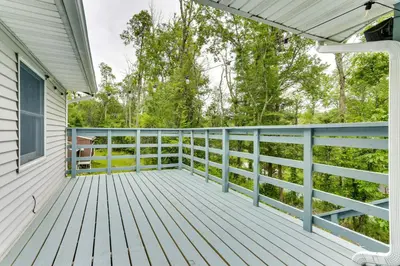 a large deck with blue railings on a house at Sauna, Fire Pit Spacious and Serene Poconos Getaway in Canadensis