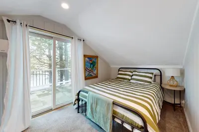 a bedroom with a bed and a large window at Heaven on Lake Harmony in Lake Harmony