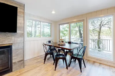 a dining room with a table and chairs and a fireplace at Heaven on Lake Harmony in Lake Harmony