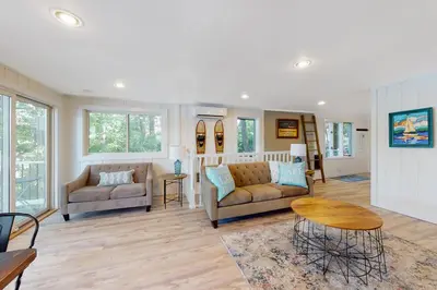 a living room with two couches and a table at Heaven on Lake Harmony in Lake Harmony