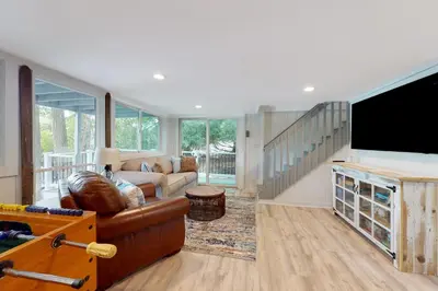 a living room with a couch and a flat screen tv at Heaven on Lake Harmony in Lake Harmony