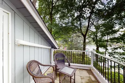 two chairs sitting on the porch of a house at Heaven on Lake Harmony in Lake Harmony