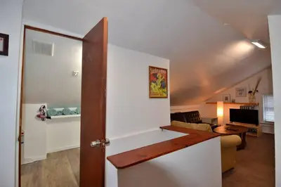 an open door to a living room with a desk at Cozy Alcove Studio Apt w Outdoor deck w NYC Views in Jersey City