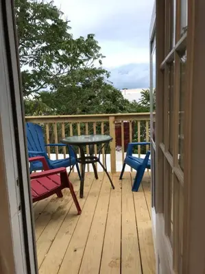 a porch with a table and chairs on a deck at Cozy Alcove Studio Apt w Outdoor deck w NYC Views in Jersey City