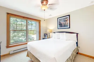 a bedroom with a white bed and a window at Maple Manor in Tannersville