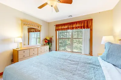 a bedroom with a large bed and a ceiling fan at Maple Manor in Tannersville