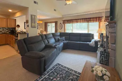 a living room with a blue couch and a table at Maple Manor in Tannersville