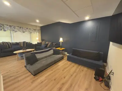 a living room with couches and a couch and a table at Maple Manor in Tannersville
