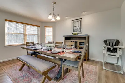 a dining room with a wooden table and chairs at Hot Tub and Lake Access Spacious Tobyhanna Home in Tobyhanna