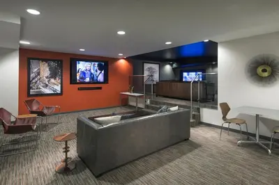 a lobby with a couch and a table and chairs at Chelsea 1BR w Roof deck Gym Doorman NYC-122 in New York