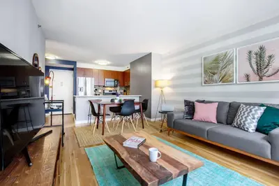 a living room with a couch and a table at Chelsea 1BR w Roof deck Gym Doorman NYC-122 in New York